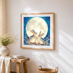 Rabbit family in the moonlight cross stitch artwork displayed on wall as home decor