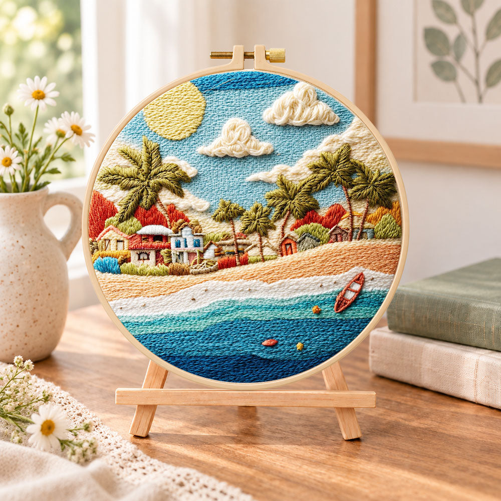 Radiant coastal hamlet embroidery kit finished hoop displayed on a wooden stand as cosy tabletop decor