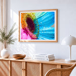 Rainbow daisy macro close up cross stitch artwork displayed on wall as home decor