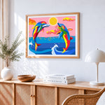 Rainbow dolphins jumping cross stitch artwork displayed on wall as home decor