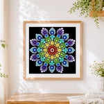 Finished rainbow dot mandala cross stitch artwork displayed