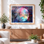 Finished rainbow full moon and tree branches cross stitch artwork displayed