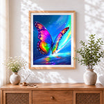 Finished rainbow glowing butterfly cross stitch artwork displayed