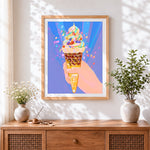 Finished rainbow ice cream cone with confetti cross stitch artwork displayed
