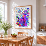 Rainbow splash cat cross stitch artwork displayed on wall as home decor