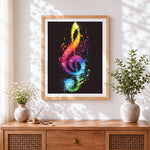 Finished rainbow splatter treble clef cross stitch artwork displayed