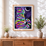 Finished rainbow striped cat in starry night paint by numbers artwork displayed as home decor