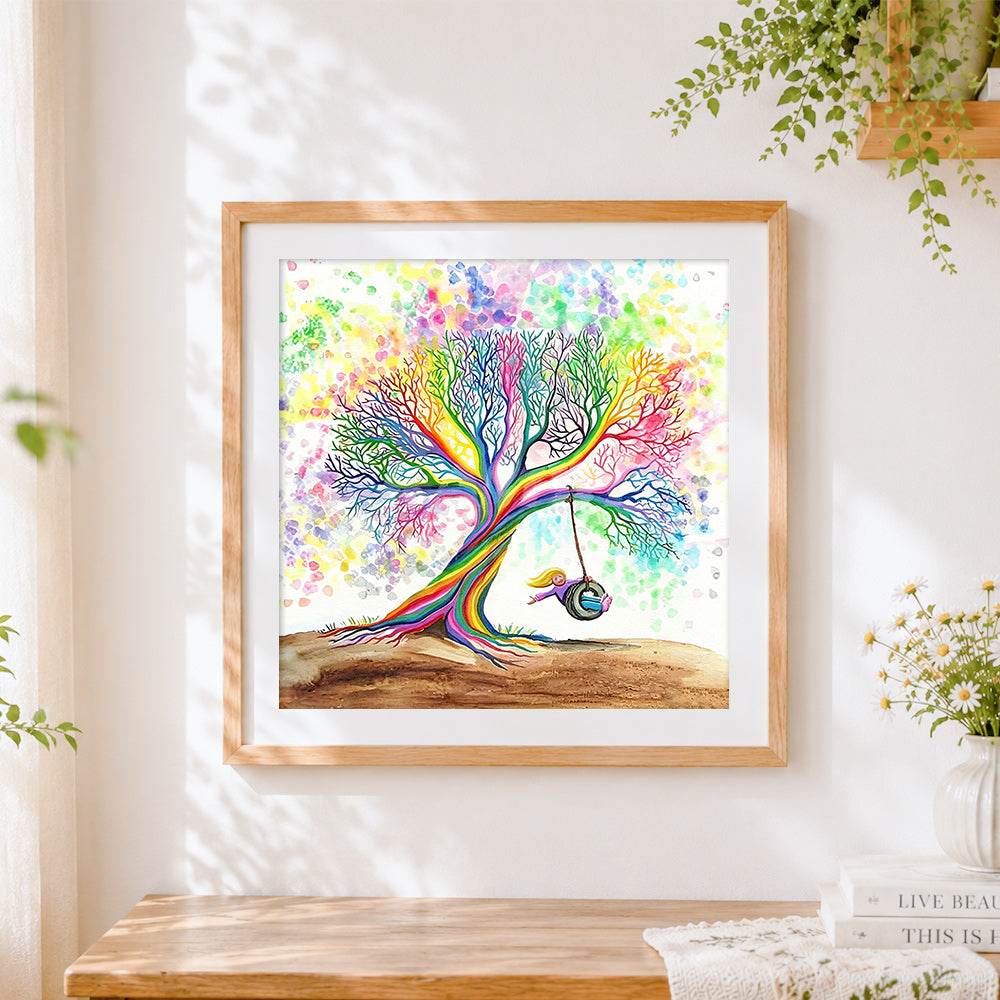Finished rainbow tree with girl on swing cross stitch artwork displayed