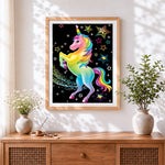 Finished rainbow unicorn and glitter stars cross stitch artwork displayed