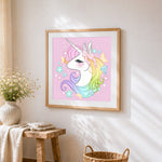 Rainbow unicorn with crystals and stars cross stitch artwork displayed on wall as home decor
