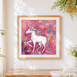 Finished rainbow unicorn with pink floral background cross stitch artwork displayed
