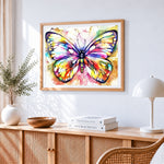 Rainbow watercolour butterfly cross stitch artwork displayed on wall as home decor