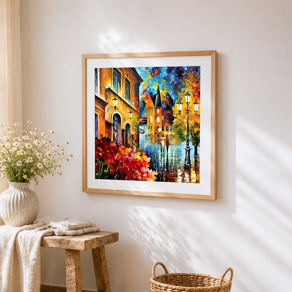 Rainy european street cross stitch artwork displayed on wall as home decor