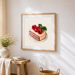 Raspberry layer cake slice cross stitch artwork displayed on wall as home decor