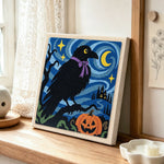 Raven with halloween night punch needle artwork displayed on a table