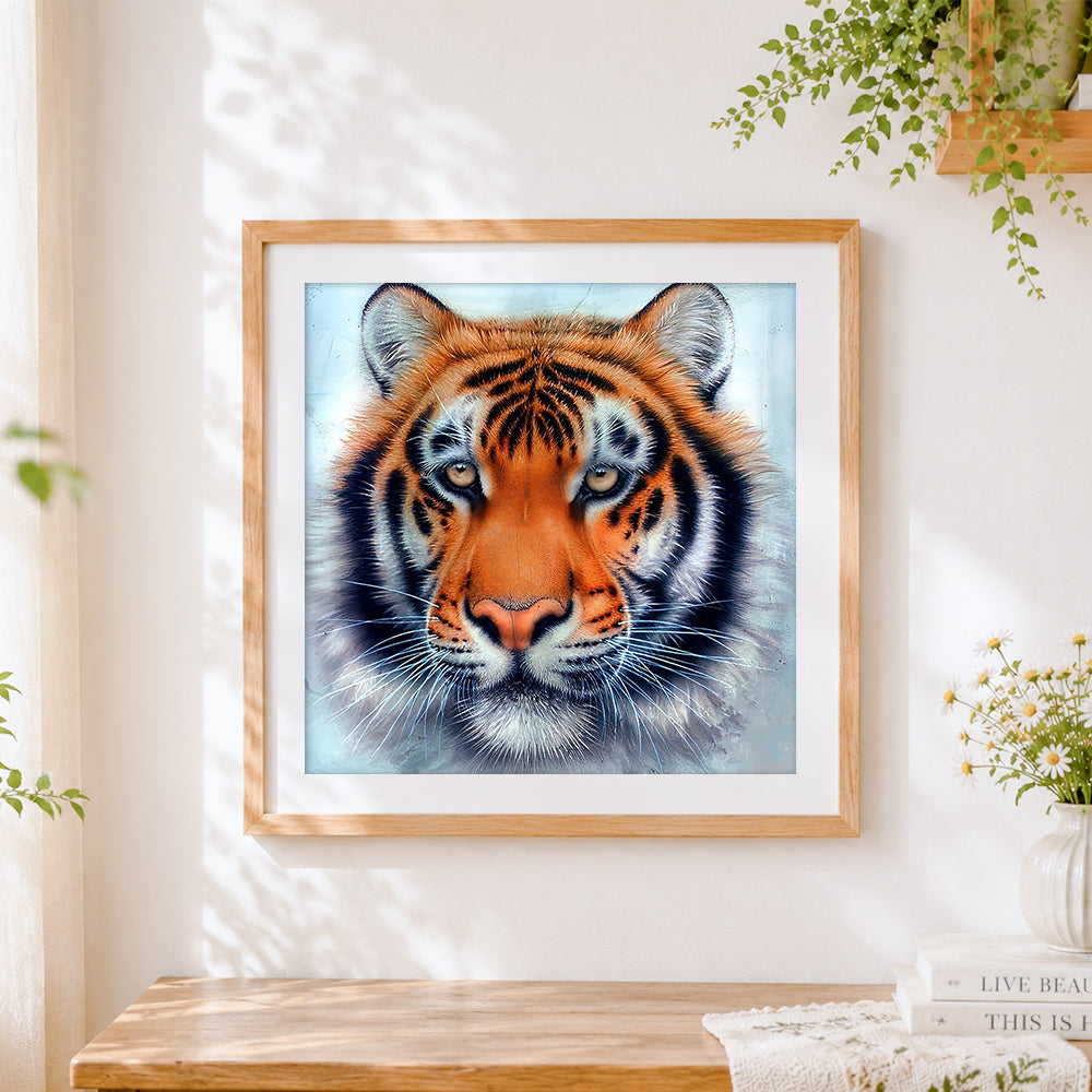 Finished realistic bengal tiger face close-up cross stitch artwork displayed