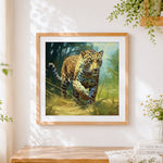 Finished realistic leopard stalking in grass cross stitch artwork displayed