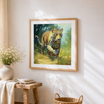 Realistic leopard stalking in grass cross stitch artwork displayed on wall as home decor