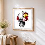 Realistic skull with colourful roses cross stitch artwork displayed on wall as home decor