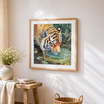 Realistic tiger drinking water cross stitch artwork displayed on wall as home decor