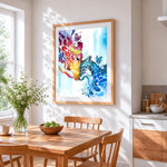 Red and blue abstract giraffes cross stitch artwork displayed on wall as home decor