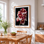 Red and white orchids on black background cross stitch artwork displayed on wall as home decor