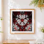 Finished red and white symmetrical mandala cross stitch artwork displayed
