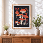 Finished red and white toadstools cross stitch artwork displayed