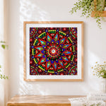 Finished red geometric mandala with eyes cross stitch artwork displayed