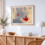 Red paper boats in the clouds cross stitch artwork displayed on wall as home decor