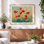Finished red poppies in a golden wheat field cross stitch artwork displayed