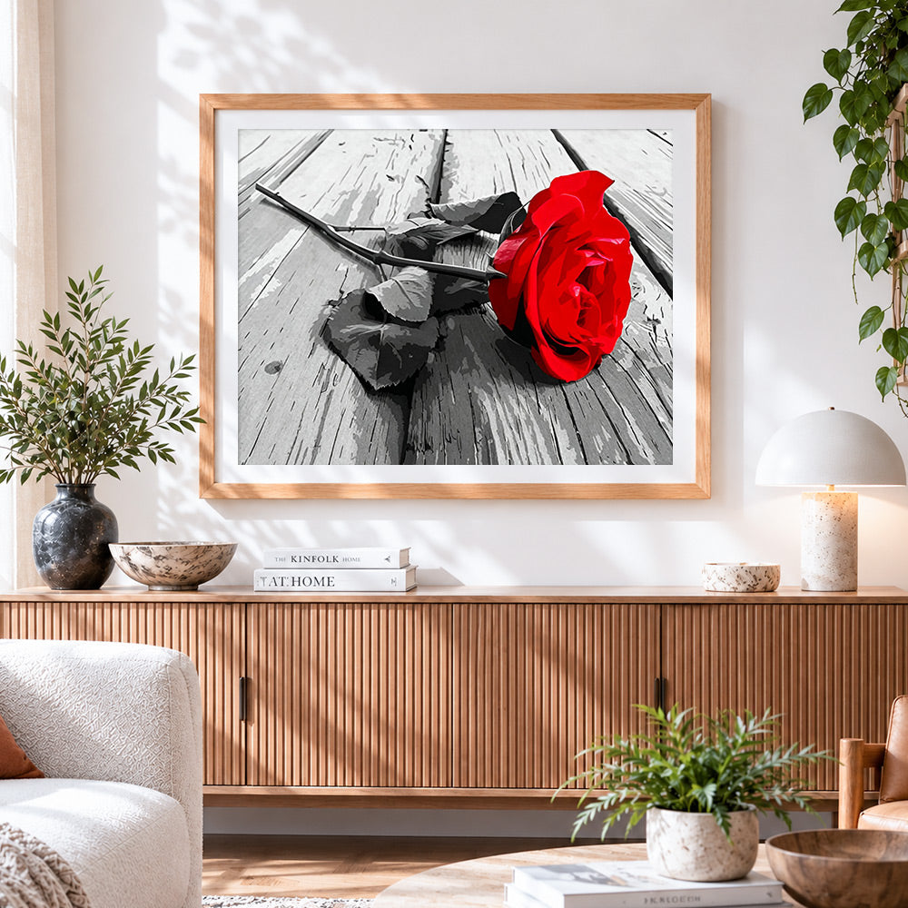 Finished red rose on weathered wood paint by numbers artwork displayed as home decor