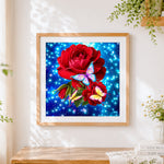 Finished red roses and colourful butterflies cross stitch artwork displayed