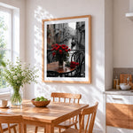 Red roses on a venice cafe table cross stitch artwork displayed on wall as home decor