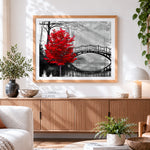 Finished red tree and bridge cross stitch artwork displayed