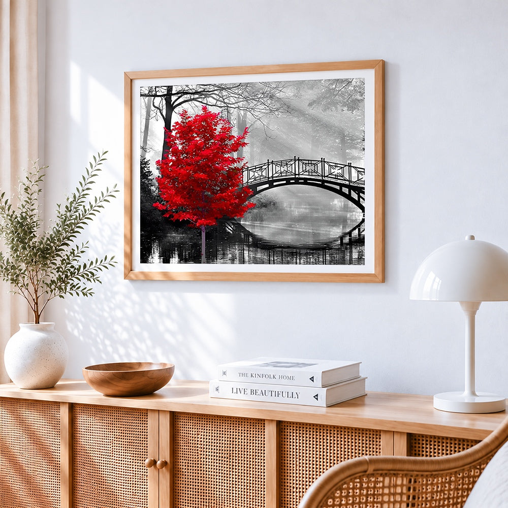 Red tree and bridge cross stitch artwork displayed on wall as home decor