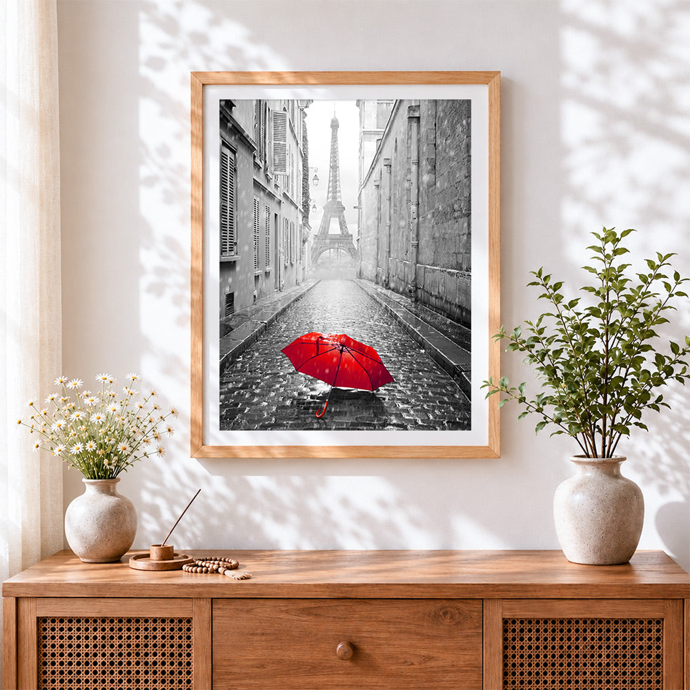 Finished red umbrella in paris cross stitch artwork displayed