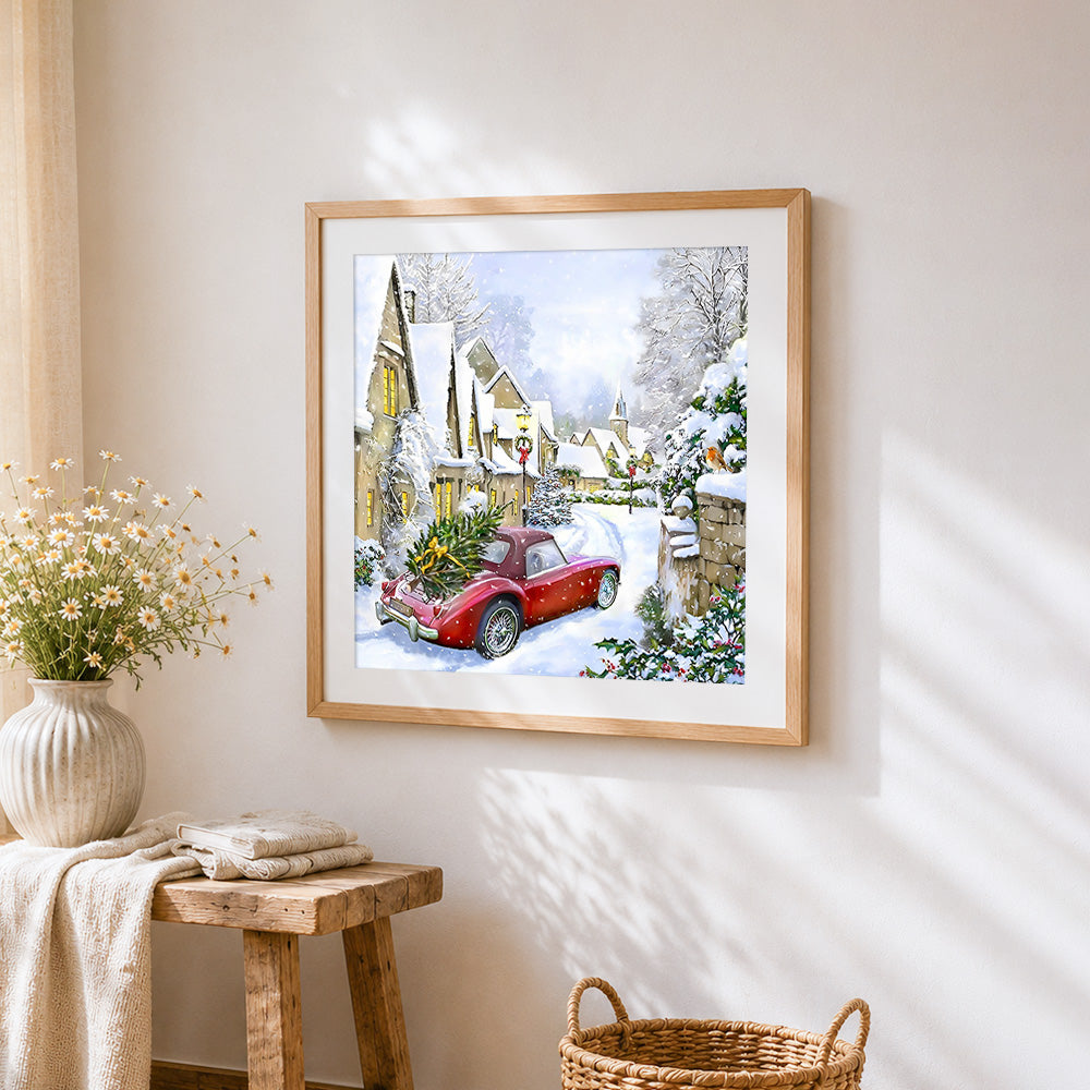 Red vintage car with christmas tree in snow cross stitch artwork displayed on wall as home decor