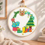 Reindeer and gifts scene embroidery hoop wall art displayed as warm and cosy handmade home decor