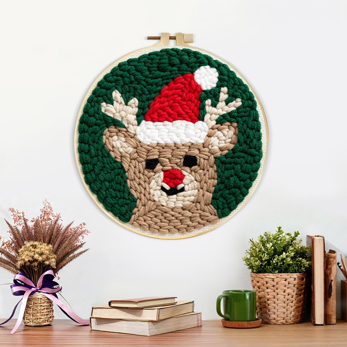 Finished reindeer with santa hat artwork displayed on a wall