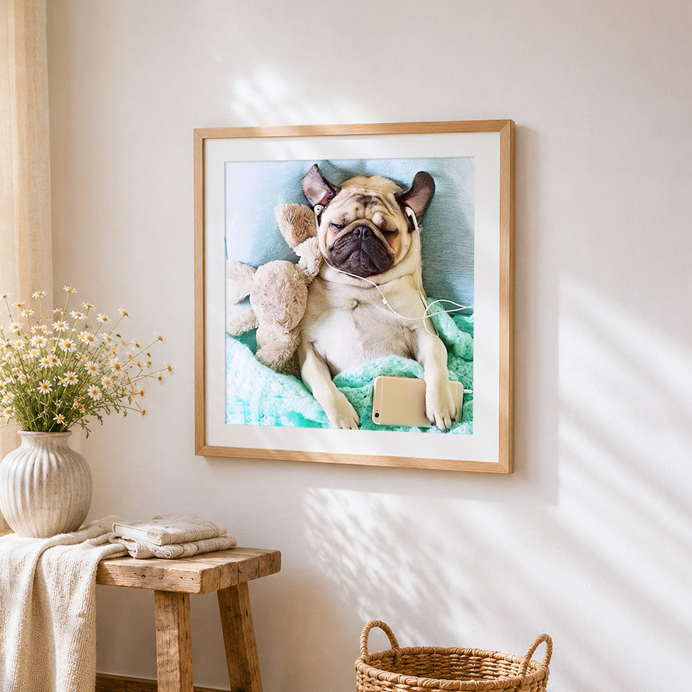 Relaxed pug with headphones and phone cross stitch artwork displayed on wall as home decor
