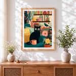 Finished retro cat and plants cross stitch artwork displayed