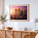 Retro-futuristic metropolis at sunrise cross stitch artwork displayed on wall as home decor