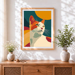 Finished retro orange and white cat cross stitch artwork displayed