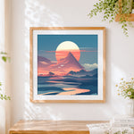 Finished retro pink sunset and mountain cross stitch artwork displayed