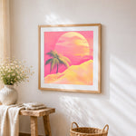 Retro pink sunset and palm cross stitch artwork displayed on wall as home decor