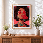 Finished retro woman with red sunglasses and rose cross stitch artwork displayed