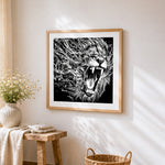 Roaring lion with water splash cross stitch artwork displayed on wall as home decor