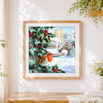Finished robin and snowy church cross stitch artwork displayed