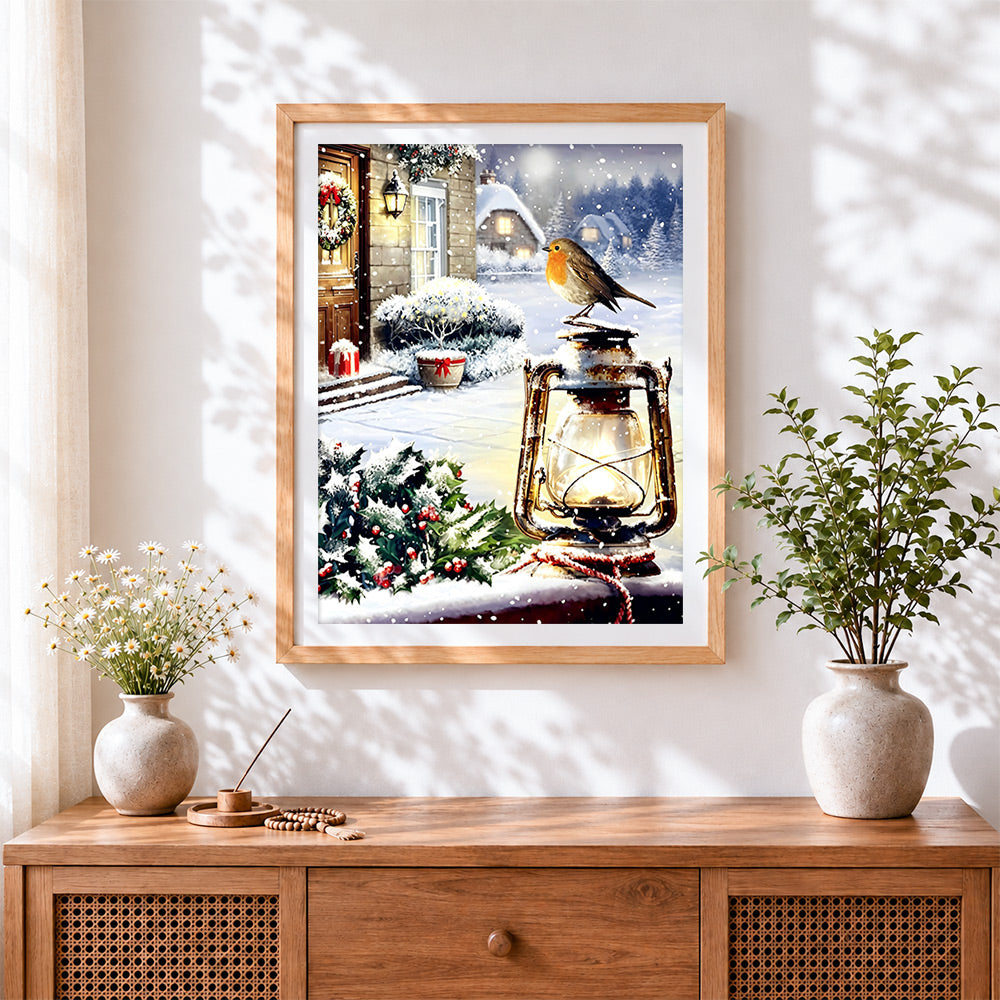 Finished robin and vintage lantern in the snow cross stitch artwork displayed